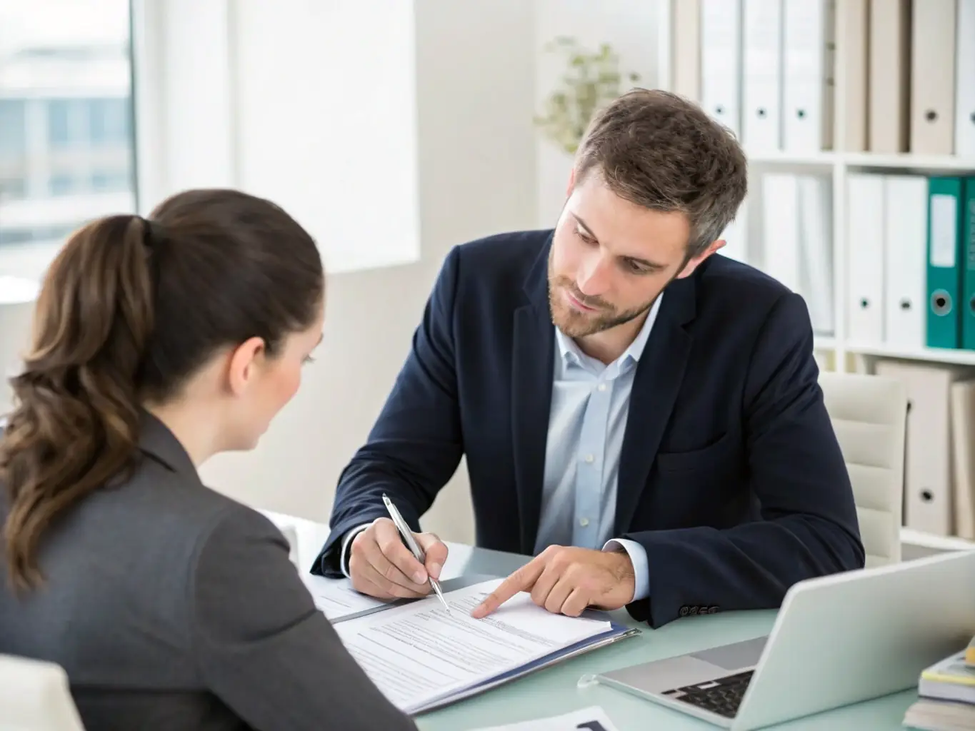 A modern office setting with accountants working on financial statements and providing advisory services to a client.